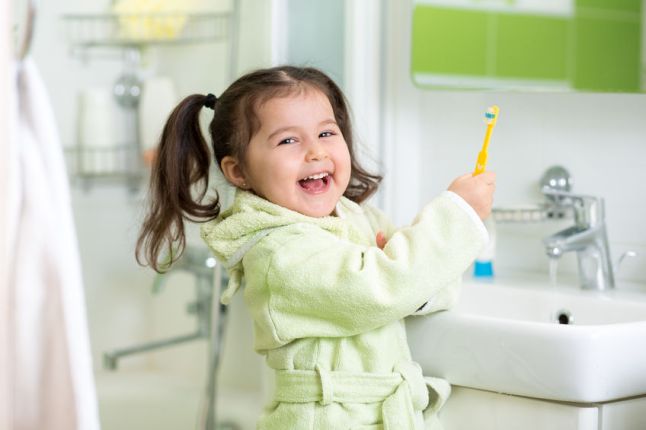 37099463 - kid little girl brushing teeth in bath