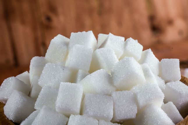 48488851 - pile of sugar cubes over wooden background